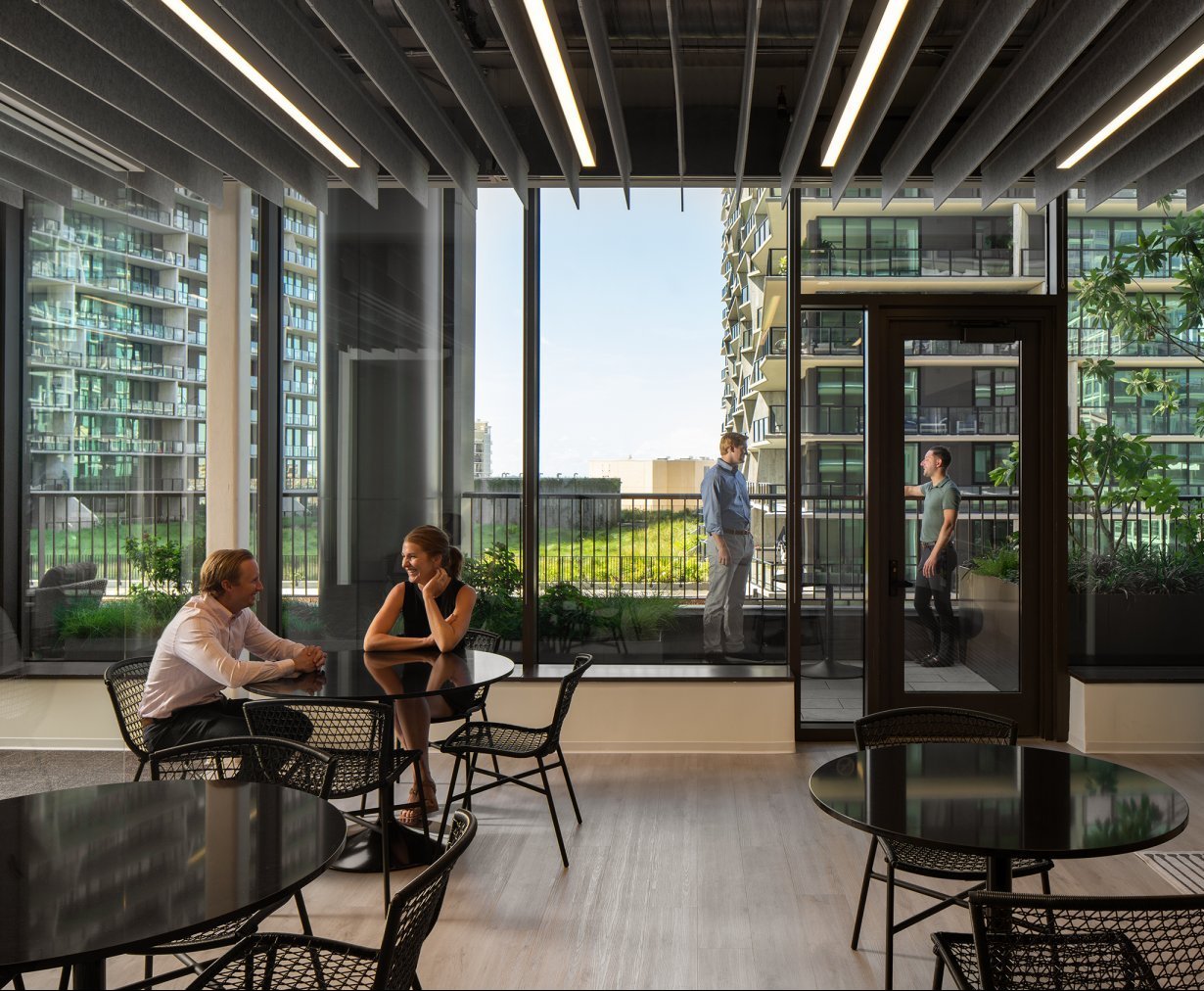 An office space at Thousand & One with floor to ceiling windows, outdoor terraces and open space for employee interactions
