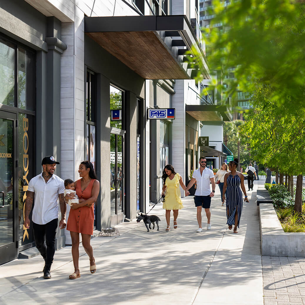 People walk amongst the vibrant streetscapes and retail in Water Street Tampa