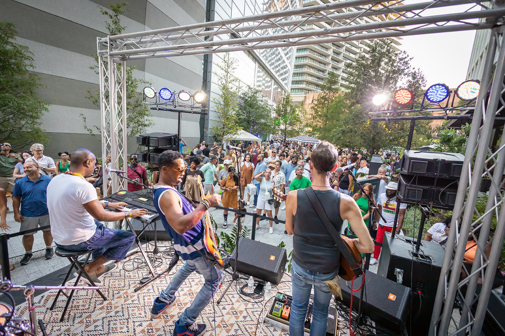 A crowd dances and sings to an outdoor stage band at Beats on the Street in Raybon Plaza at Water Street Tampa