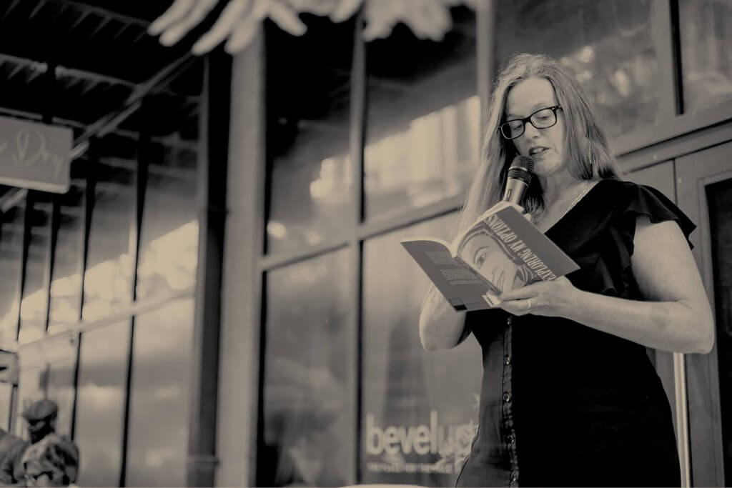 an author reads a book live at Cover to Cover book fair in water street tampa